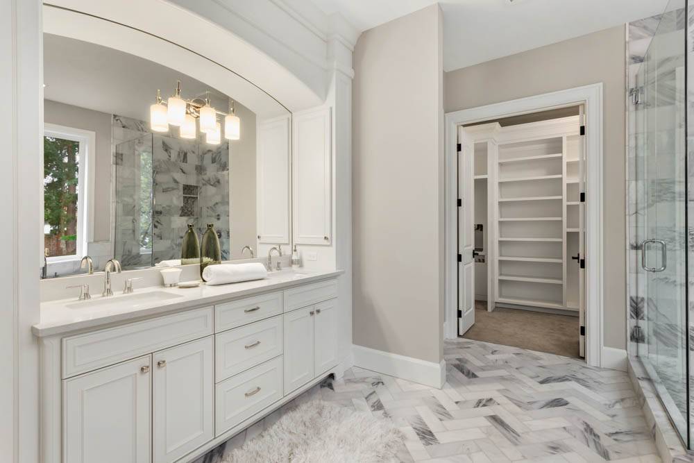 Master bathroom in new luxury home with double vanity and view