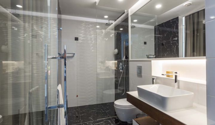 Interior of a luxury hotel bathroom with glass shower cabin