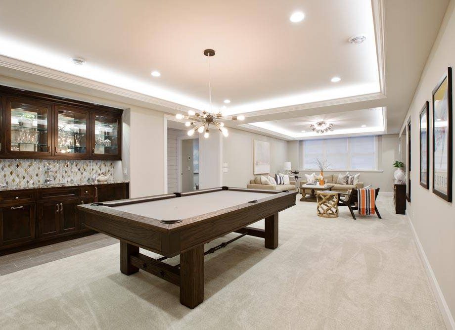 Beautiful basement entertaining room with LED lighting in tray ceiling
