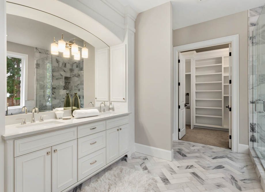 Master bathroom in new luxury home with double vanity and view