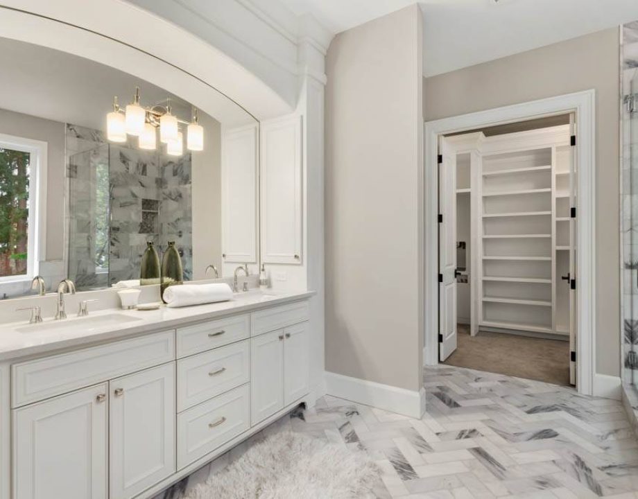 Master bathroom in new luxury home with double vanity and view